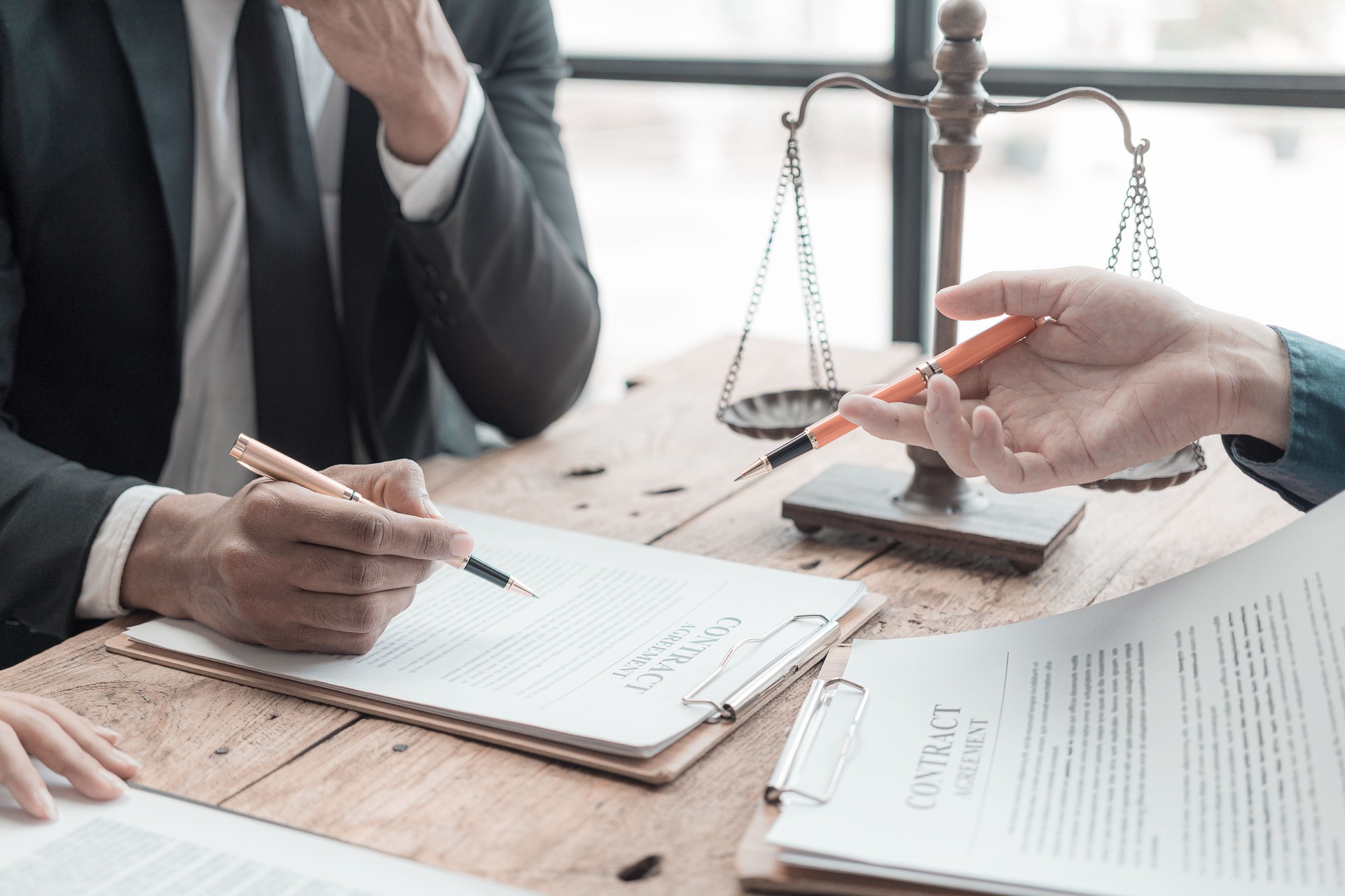 Male lawyer working with contract documents and wooden hammer on table in courtroom justice and law Judge in suit or lawyer working with documents Law, advice, close-up pictures